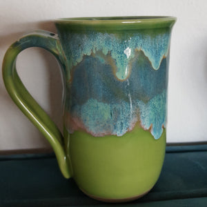 green mug with blue/green